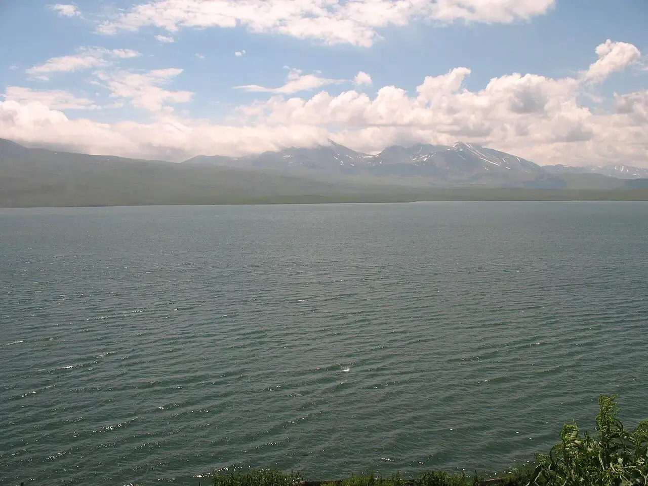 Wide grey surface of Tabatskuri lake under clouds